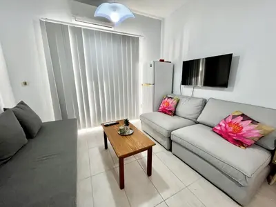 a living room with a couch and a table at STAY McKenzie Mile in Larnaka