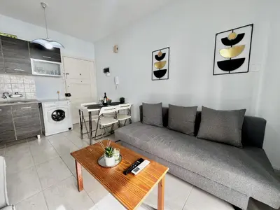 a living room with a couch and a table at STAY McKenzie Mile in Larnaka