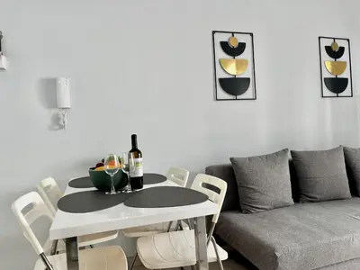 a living room with a table and a couch at STAY McKenzie Mile in Larnaka