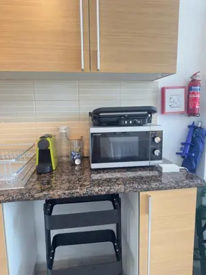 a kitchen with a counter top with a microwave at A Home at Coralli - Protaras Beach Apartment, 30 m from beach in Protaras