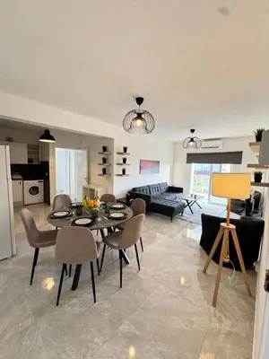 a kitchen and living room with a table and chairs at Napa Skyline Suite 3BR Sunset Views and Pool in Ayia Napa