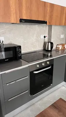 a kitchen with a microwave and a stove top oven at Rıversıdelıfe Iskele 164 in Vuda