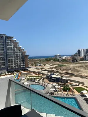 a view of a resort with two swimming pools at Rıversıdelıfe Iskele 164 in Vuda