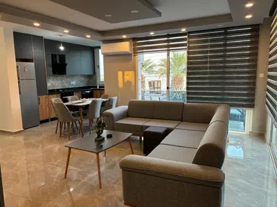 a living room with a couch and a table at Veray Homes, Alsancak in Ayios Dhometios
