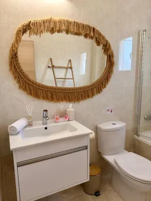 a bathroom with a sink and a toilet and a mirror at Rope and Reef 2BD Walk to Nissi Beach and Pool in Ayia Napa