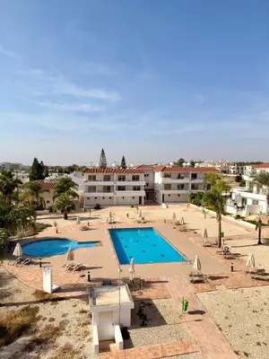 a view of a swimming pool with a resort at Rope and Reef 2BD Walk to Nissi Beach and Pool in Ayia Napa