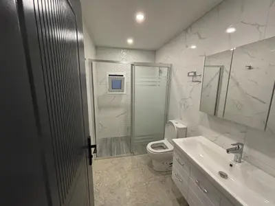 a bathroom with a shower and a toilet and a sink at Veray Homes Villa in Ayios Dhometios