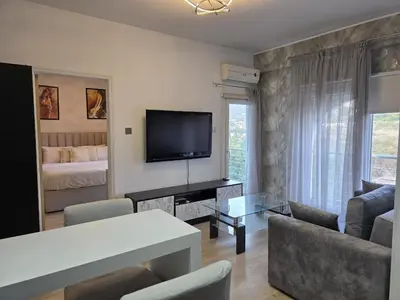 a living room with a couch and a television at White Arches Haven by Staycom in Limassol