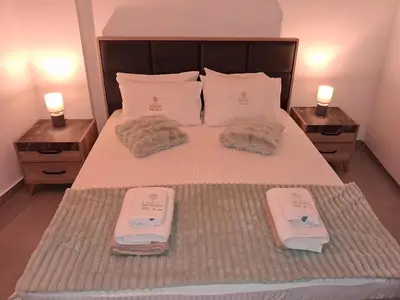 a bedroom with a bed with two towels on it at Lazuli City Center Ap 11 in Larnaka