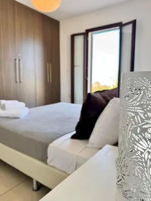 a bedroom with a bed and a window at Aurora Gardens Villa Spacious 3 Bedroom in Protaras in Paralimni