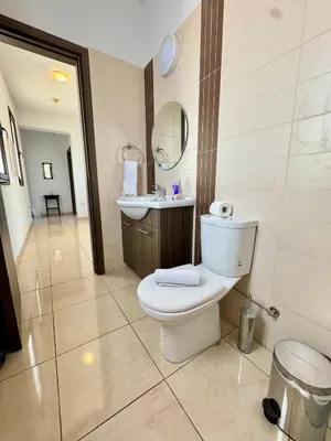 a bathroom with a toilet and a sink at Aurora Gardens Villa Spacious 3 Bedroom in Protaras in Paralimni