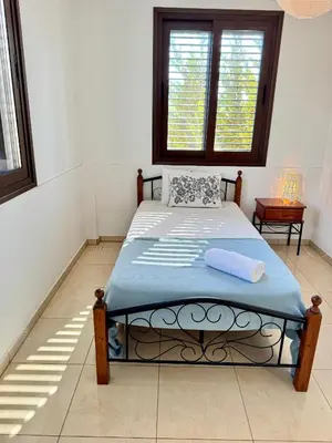 a bedroom with a bed in a room with windows at Aurora Gardens Villa Spacious 3 Bedroom in Protaras in Paralimni