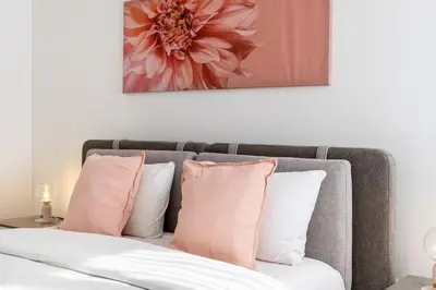 a bedroom with a bed with pink and white pillows at Averna - Breezy 2-BR Apt & Balcony in Larnaca in Larnaka