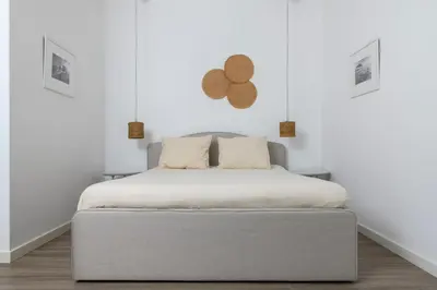 a bed in a room with white walls at Bright 2BR by Pedieos Park, near Old Town in Nicosia