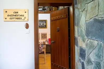 a door to a kitchen with a sign on it at Gazingstars Cottages Agridia