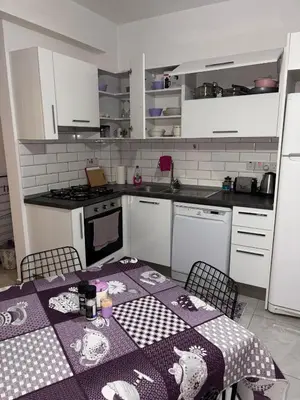 a kitchen with a table with a table cloth on it at Lapta Purple 2 bedroom in Peristerona
