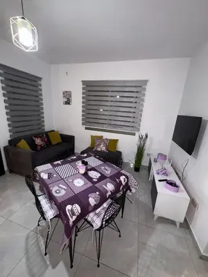 a living room with a table and a couch at Lapta Purple 2 bedroom in Peristerona