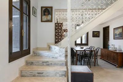a staircase in a home with a table and chairs at Horizon View Lefkara with Pool, Garden, Parking in Pano Lefkara