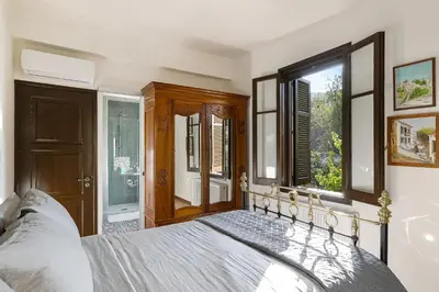 a bedroom with a bed and a window at Horizon View Lefkara with Pool, Garden, Parking in Pano Lefkara