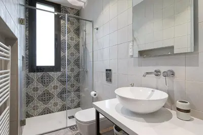 a bathroom with a white sink and a shower at Horizon View Lefkara with Pool, Garden, Parking in Pano Lefkara