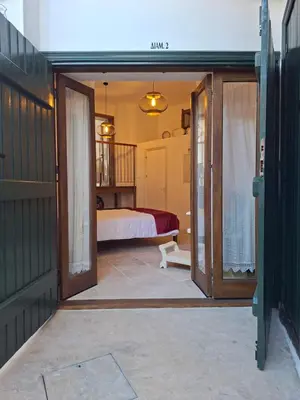 an open door to a bedroom with a bed at Cecilia Traditional House-Suites in Kalopanayiotis