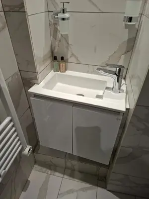 a bathroom with a white sink and a mirror at Cecilia Traditional House-Suites in Kalopanayiotis