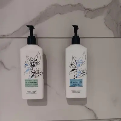 two bottles of lotion sitting on a wall at Cecilia Traditional House-Suites in Kalopanayiotis