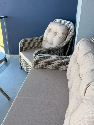 a bedroom with a bed and a chair and a couch at Studıo Iskele 150 in Aglantzia