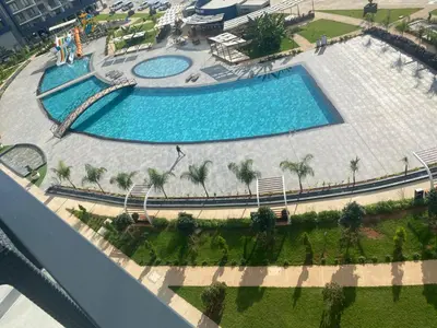 an overhead view of two swimming pools with palm trees at Studıo Iskele 150 in Aglantzia