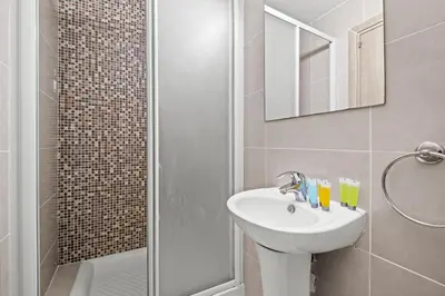 a bathroom with a sink and a shower at Downtown 2 Bedroom City Flat in Larnaka