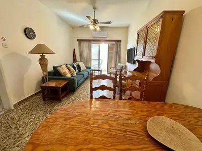 a living room with a couch and a table at 2 bedroom flat by the sea in Larnaka
