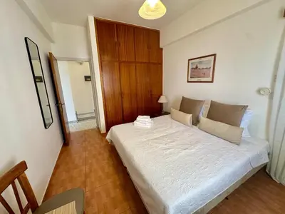 a bedroom with a large white bed in a room at 2 bedroom flat by the sea in Larnaka