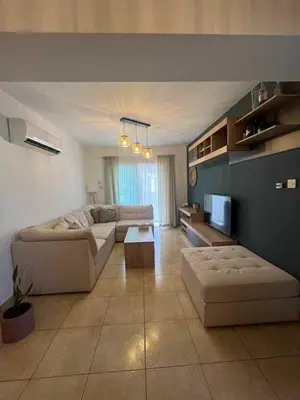 a living room with a couch and a tv at 2 bedroom flat in centre in Larnaka