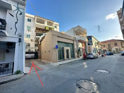 a street with a red arrow on the side of a building at 2 bedroom flat in centre in Larnaka