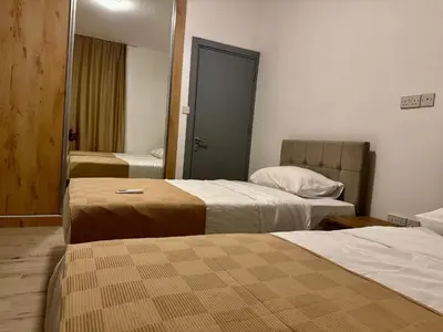 a hotel room with two beds and a mirror at Soğular Apartments 1 in Aglantzia