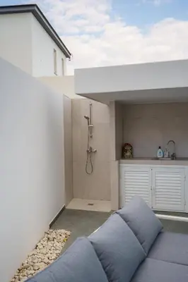 a bathroom with a shower and a blue pillow at Villa Oro Hills w private hot tub jacuzzi in Voroklini