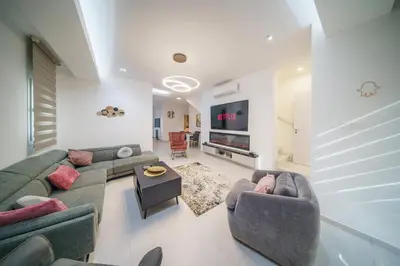 a living room with two couches and a flat screen tv at Villa Oro Hills w private hot tub jacuzzi in Voroklini