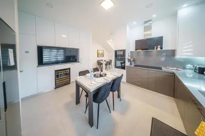 a kitchen with a table and some chairs in a room at Villa Oro Hills w private hot tub jacuzzi in Voroklini