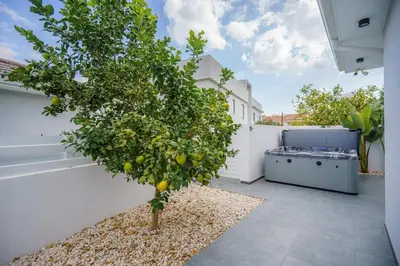 a lemon tree on a patio with a grill at Villa Oro Hills w private hot tub jacuzzi in Voroklini