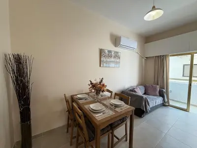 a living room with a table and a couch at One-bedroom apartment next to Radisson Blu in Larnaka