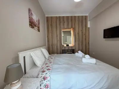 a bedroom with a white bed with towels on it at One-bedroom apartment next to Radisson Blu in Larnaka