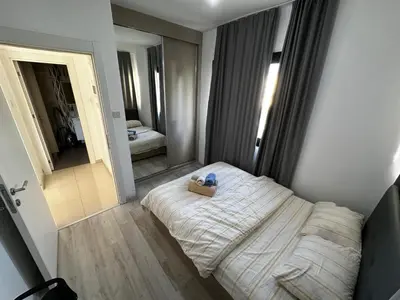 a small bedroom with a bed and a mirror at Avrasya site, Luxury one-bedroom apartment in Kyrenia city center