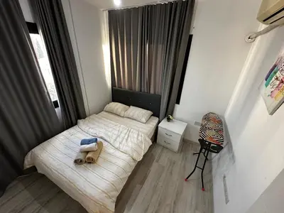 a small bedroom with a bed with a teddy bear on it at Avrasya site, Luxury one-bedroom apartment in Kyrenia city center