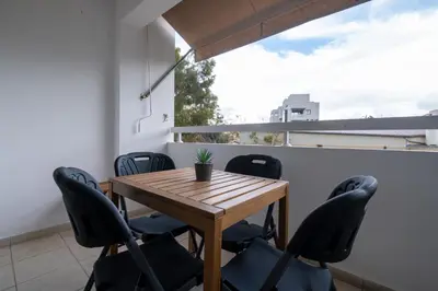 a dining room with a wooden table and chairs at Downtown Stadium 3 Bedroom Apartment in Larnaka