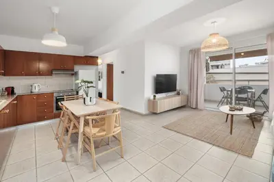 a kitchen and living room with a table and chairs at Downtown Stadium 3 Bedroom Apartment in Larnaka