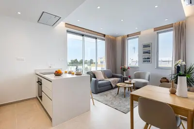 a kitchen and living room with a table and chairs at Chrystal Residences in Nicosia