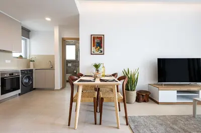 a kitchen and dining room with a table and chairs at Chrystal Residences in Nicosia