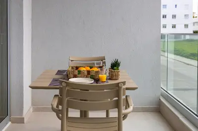 a table with two chairs and a basket of fruit at Chrystal Residences in Nicosia