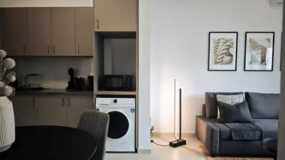 a living room with a couch and a dishwasher at City and Sea 12 in Larnaka