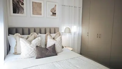 a bedroom with a white bed with pillows on it at City and Sea 12 in Larnaka
